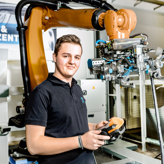 A prospective industrial mechanic learns how to operate an industrial robot.