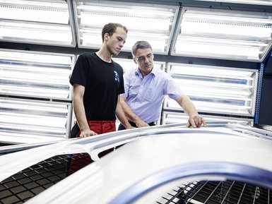 Two EBZ Group employees make a quality control check on a sidewall manufactured by EBZ.