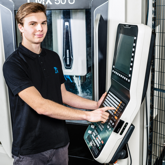 A prospective machinist learns how to work with a CNC milling machine.