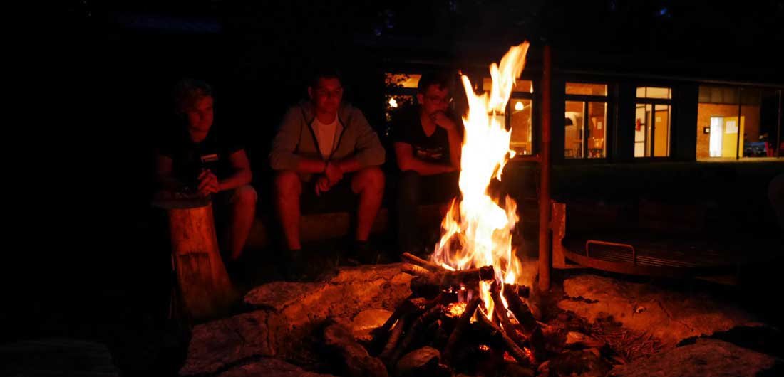 On orientation days, the new trainees gathered together around the campfire.